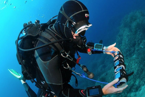 Diver looking at many dive computers