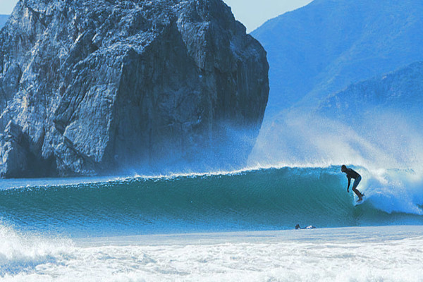 surfer in front of witch rock