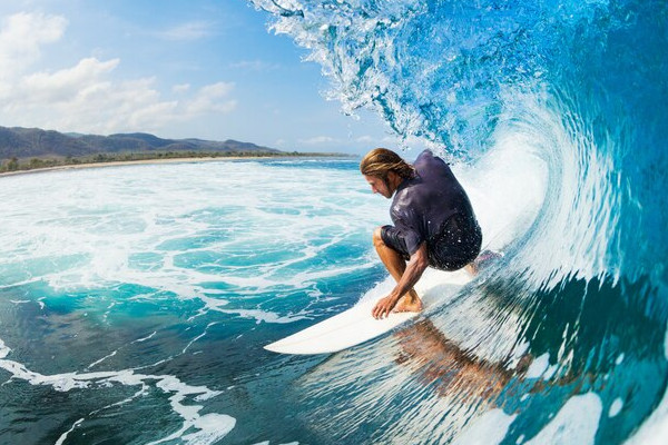 surfer sliding down the inner part of a wave