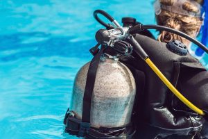 Scuba diver carrying her tank