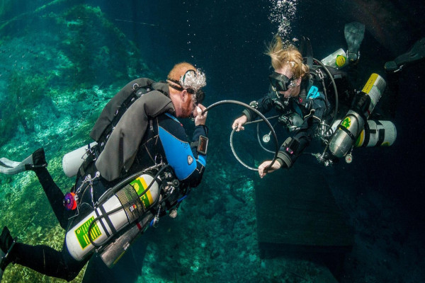 Divers sharing air tank