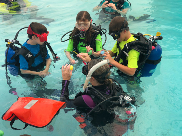 kids scuba diving at summer camp