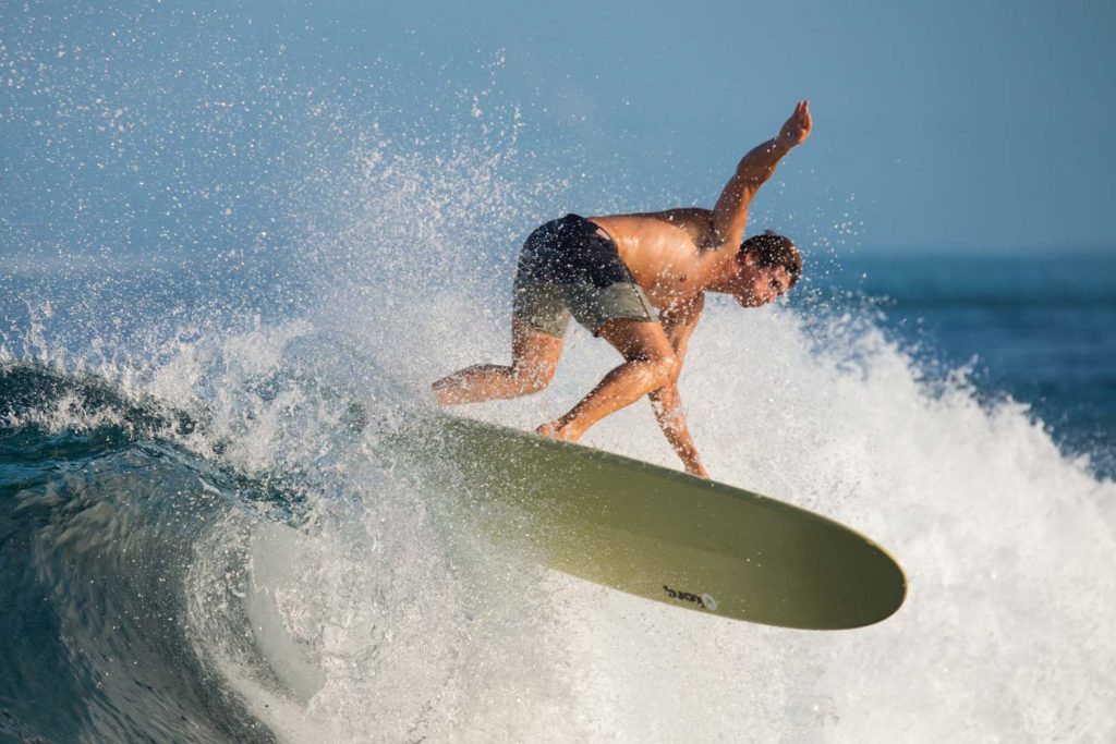 surfer using a Torq 9’0” longboard