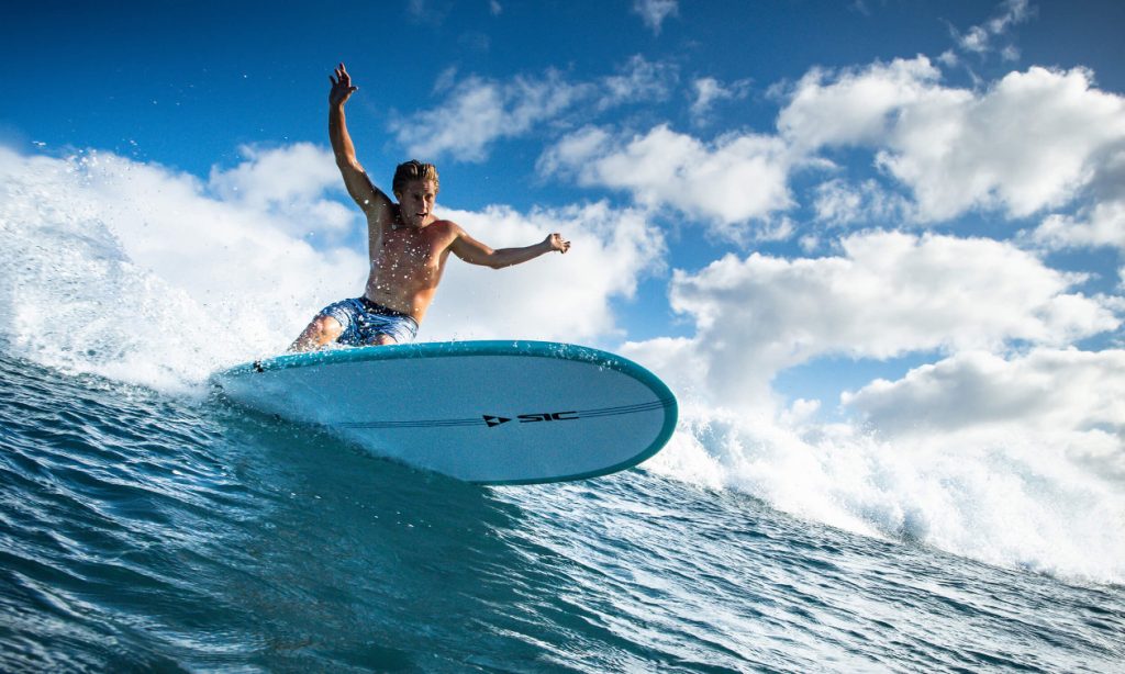 advance surfer starting to ride a wave