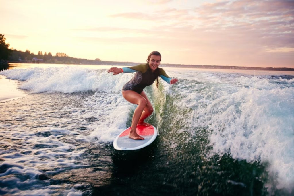 A woman riding a wave on a surfboard-learning to surf